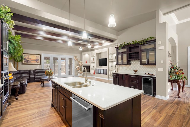 2425 Cesar Cordova Pl, El Paso, TX 79938 - kitchen with pendant lighting, sink, appliances with stainless steel finishes, backsplash, and wine cooler