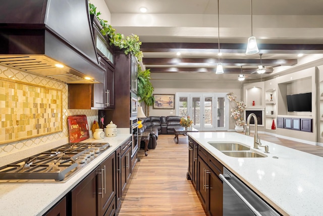 2425 Cesar Cordova Pl, El Paso, TX 79938 - kitchen featuring ceiling fan, sink, backsplash, premium range hood, and decorative light fixtures