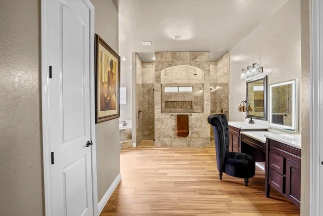 2425 Cesar Cordova Pl, El Paso, TX 79938 - bathroom featuring a tile shower, vanity, and hardwood / wood-style floors