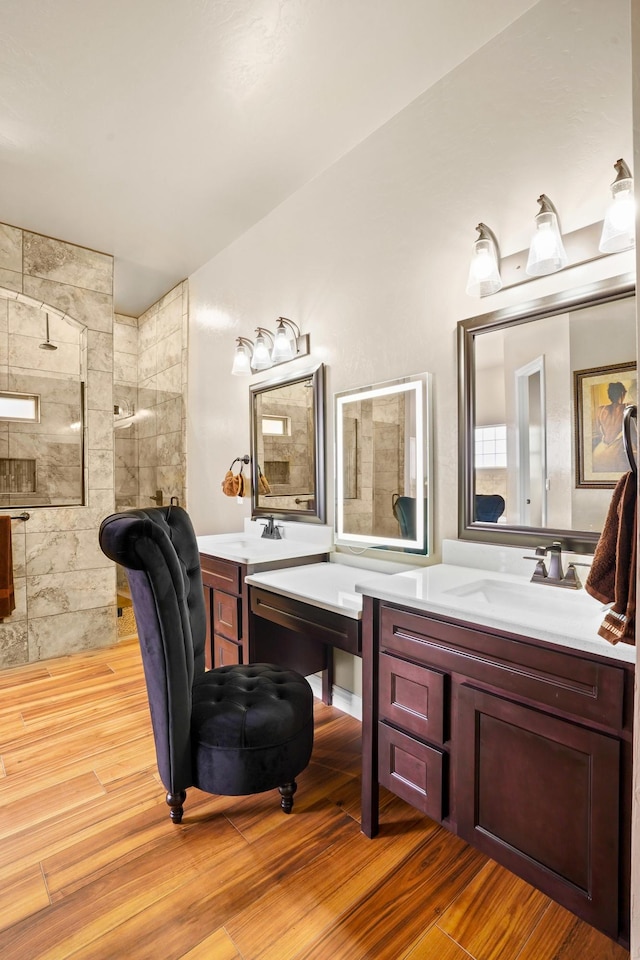 2425 Cesar Cordova Pl, El Paso, TX 79938 - bathroom with vanity, a tile shower, and hardwood / wood-style floors