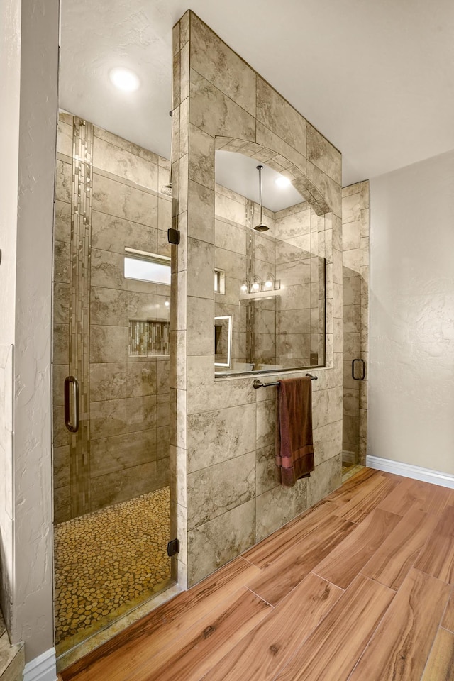2425 Cesar Cordova Pl, El Paso, TX 79938 - bathroom featuring a shower with shower door and wood-type flooring