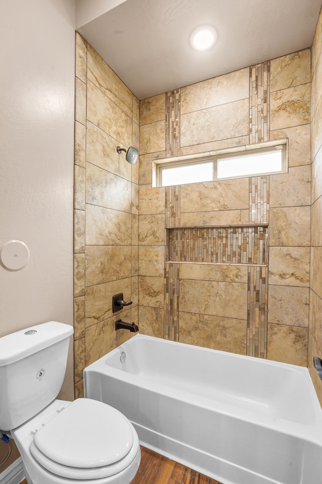2425 Cesar Cordova Pl, El Paso, TX 79938 - bathroom featuring tiled shower / bath, toilet, and wood-type flooring