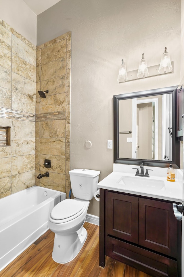 2425 Cesar Cordova Pl, El Paso, TX 79938 - full bathroom featuring toilet, hardwood / wood-style floors, vanity, and tiled shower / bath