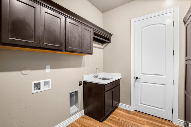 2425 Cesar Cordova Pl, El Paso, TX 79938 - laundry area with washer hookup, light hardwood / wood-style flooring, cabinets, and sink