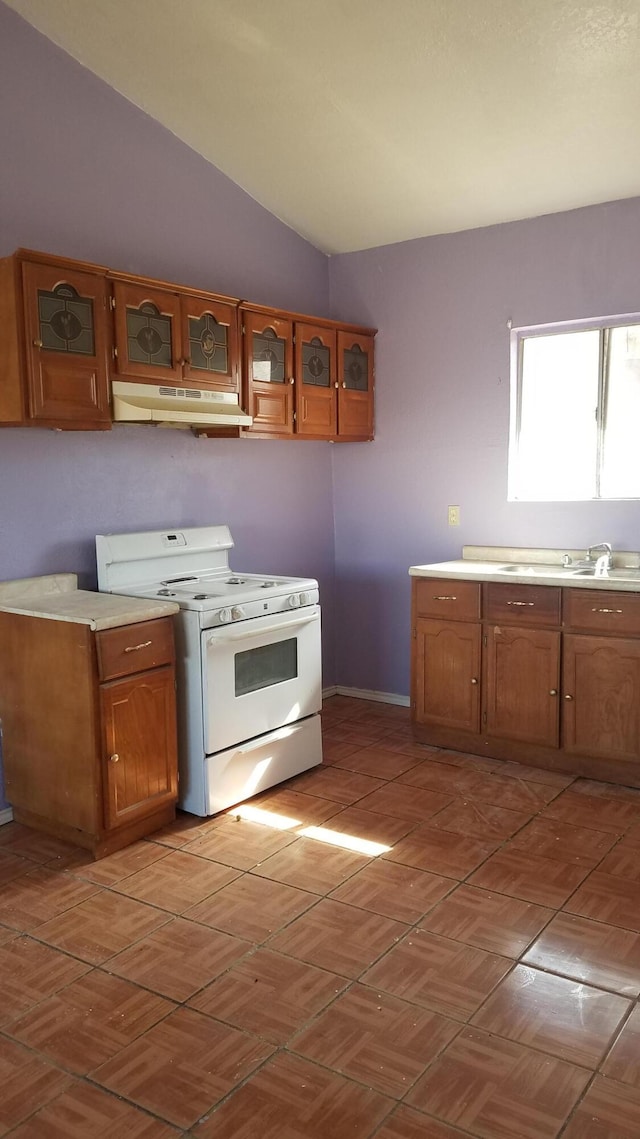 kitchen with white range oven and vaulted ceiling