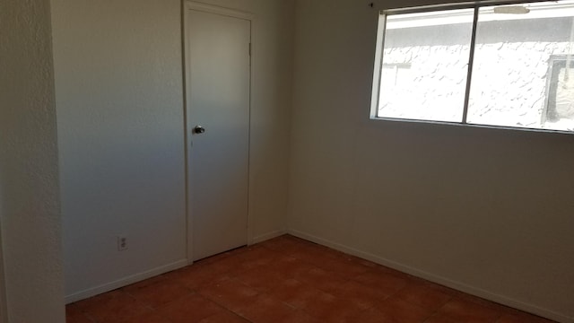 unfurnished room with tile flooring