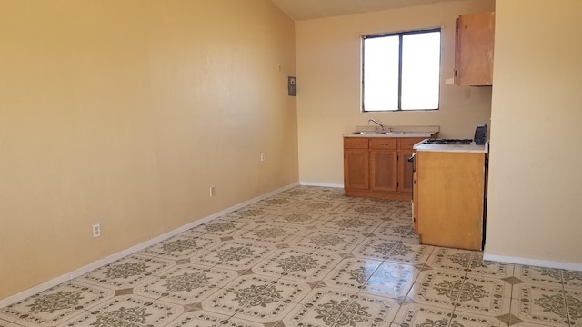 kitchen with sink and light tile floors