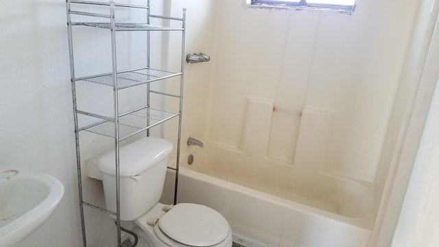 full bathroom featuring toilet, bathing tub / shower combination, and sink