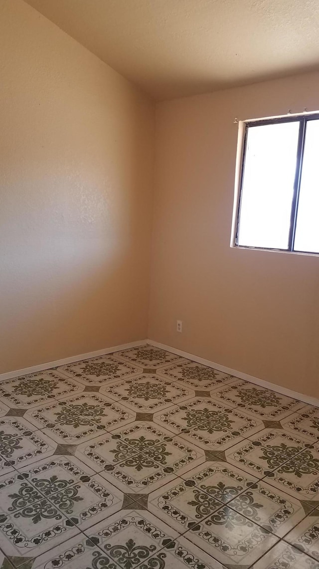 unfurnished room with tile flooring