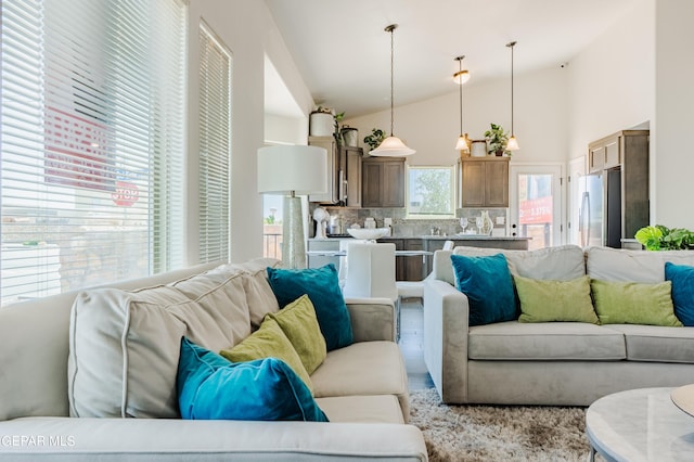 living room with high vaulted ceiling