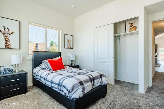 bedroom featuring arched walkways, baseboards, a closet, and carpet floors