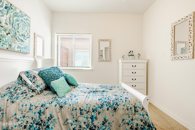 carpeted bedroom with baseboards