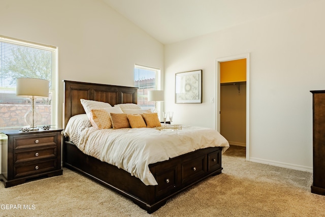 bedroom with light carpet, high vaulted ceiling, a closet, baseboards, and a spacious closet