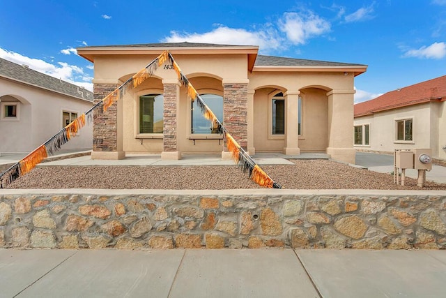 mediterranean / spanish home with a patio