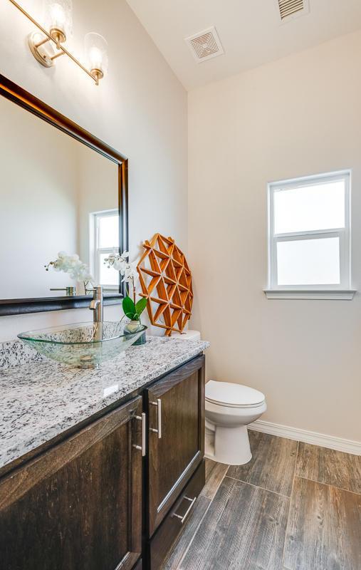 bathroom featuring hardwood / wood-style flooring, toilet, and vanity