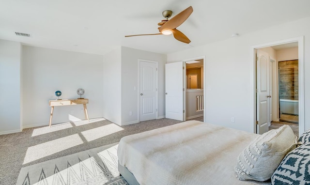 bedroom with ceiling fan, connected bathroom, and light carpet