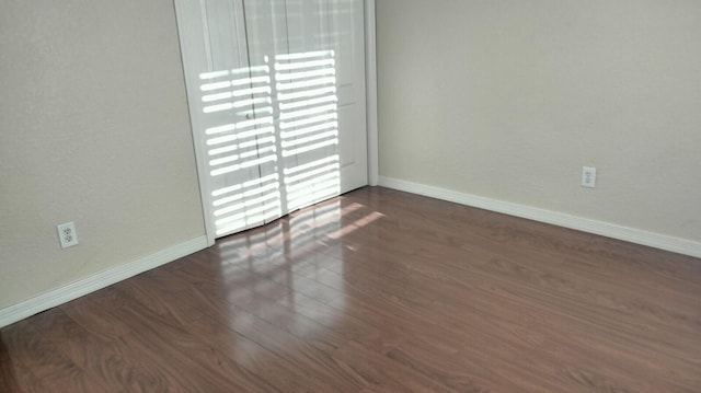 unfurnished room featuring dark hardwood / wood-style floors