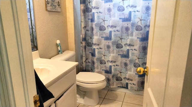 bathroom featuring toilet, large vanity, and tile flooring