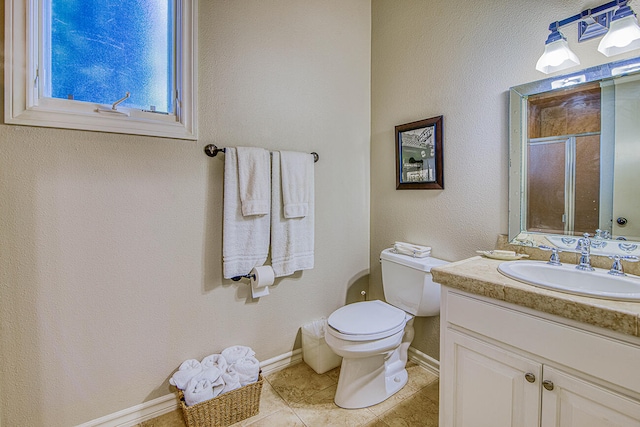 bathroom featuring tile flooring, vanity with extensive cabinet space, and toilet