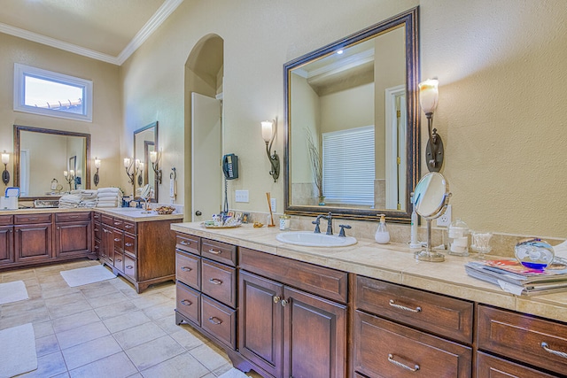 bathroom with oversized vanity, ornamental molding, dual sinks, and tile flooring