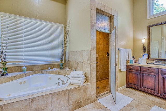 bathroom with vanity, tile flooring, and independent shower and bath