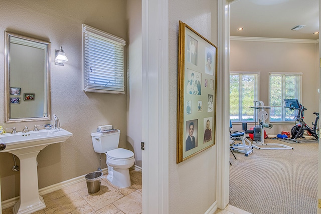 bathroom with tile floors, toilet, and ornamental molding