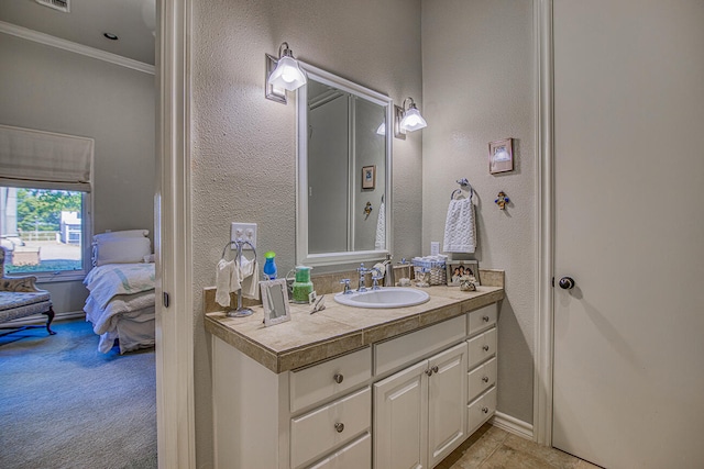 bathroom with vanity and ornamental molding