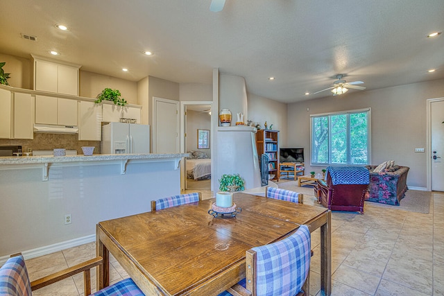 tiled dining room featuring ceiling fan