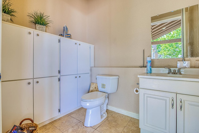 bathroom with vanity, tile floors, and toilet