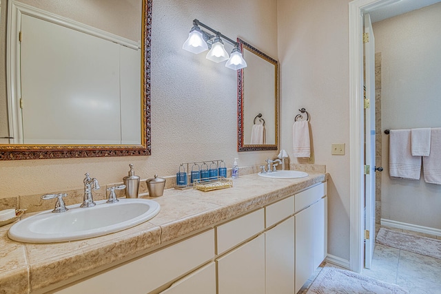 bathroom with double vanity and tile flooring