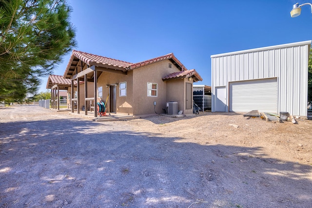 exterior space featuring central AC and a garage