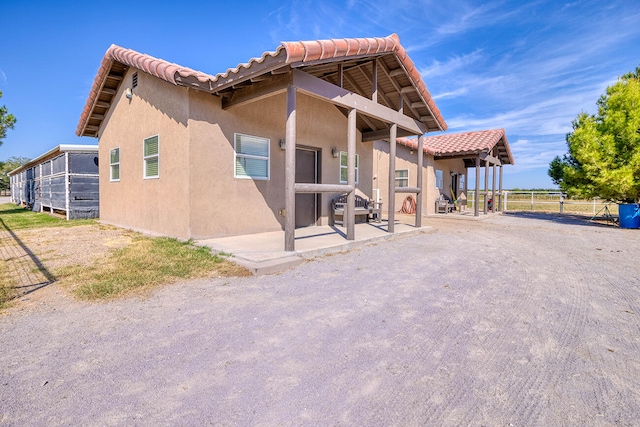 view of property exterior featuring a patio area