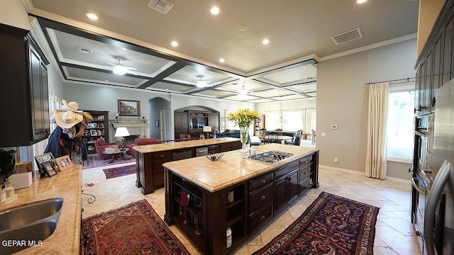 kitchen featuring coffered ceiling, ceiling fan, appliances with stainless steel finishes, light tile floors, and ornamental molding