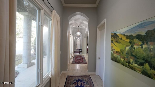 corridor featuring crown molding and light tile floors