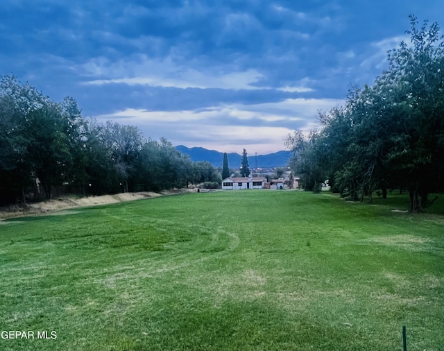 view of home's community featuring a lawn and a mountain view