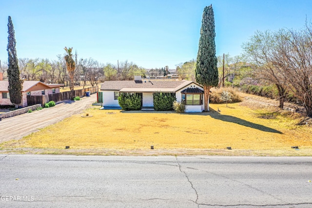 view of front of house with a front lawn and fence