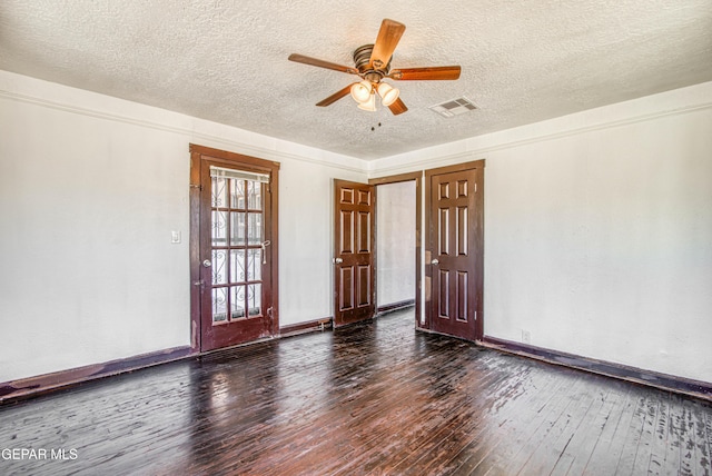 unfurnished room featuring ceiling fan, visible vents, a textured ceiling, and hardwood / wood-style floors