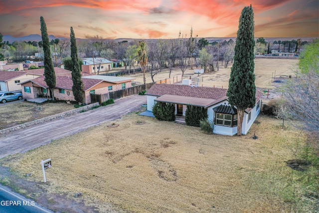 aerial view at dusk featuring a residential view and a mountain view