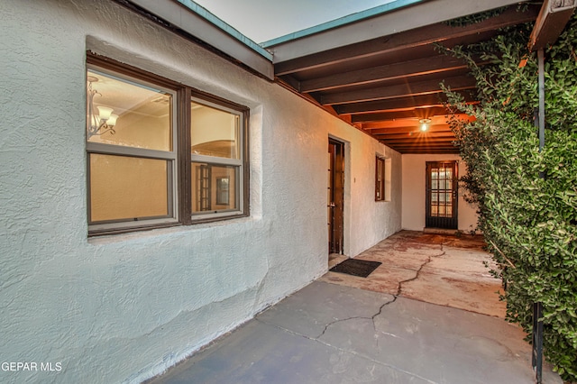 doorway to property with stucco siding and a patio