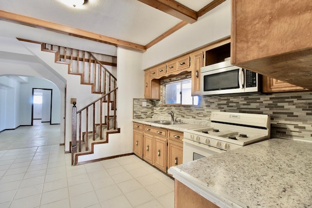 kitchen featuring light tile floors, white range with electric cooktop, beamed ceiling, tasteful backsplash, and sink