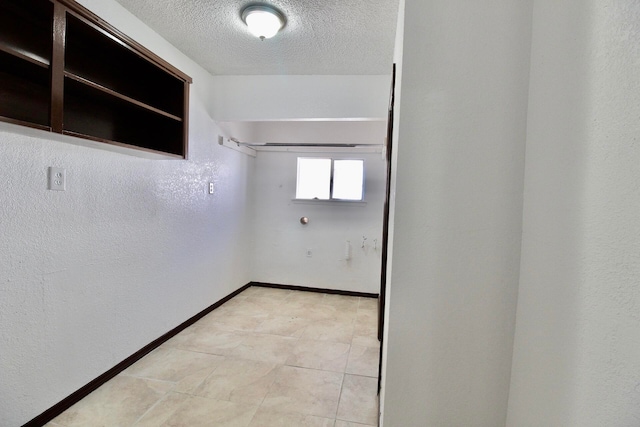 walk in closet featuring light tile floors