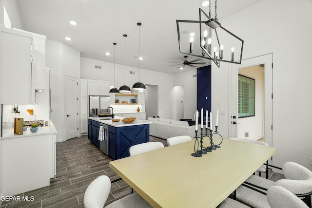 dining area featuring recessed lighting, visible vents, ceiling fan with notable chandelier, and wood finish floors