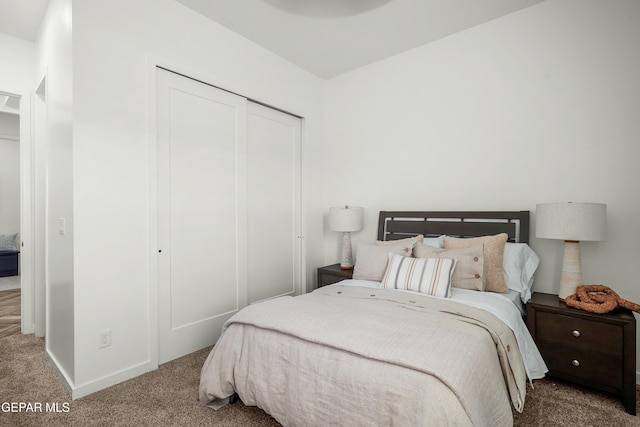 bedroom with a closet, carpet flooring, and baseboards