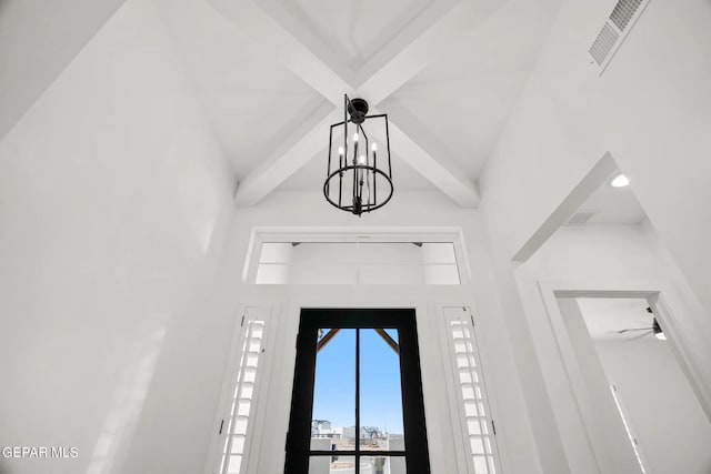 details featuring an inviting chandelier, visible vents, and beamed ceiling