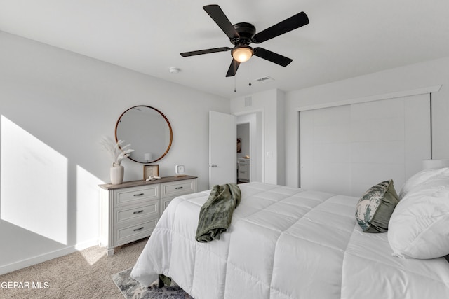 carpeted bedroom featuring ceiling fan and a closet