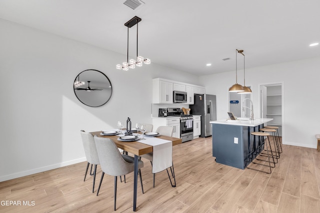 dining space featuring light wood-type flooring