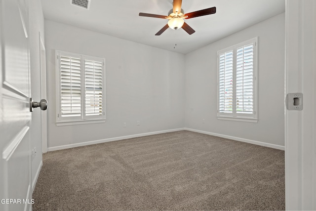 carpeted spare room with ceiling fan