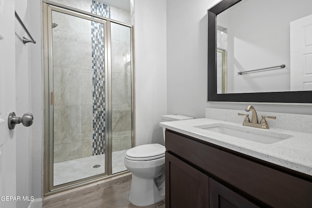 2517 Tony Harper St, El Paso, TX 79938 - bathroom featuring toilet, vanity, a shower with door, and hardwood / wood-style flooring
