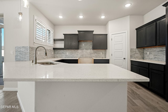 2517 Tony Harper St, El Paso, TX 79938 - kitchen with pendant lighting, backsplash, sink, and dark wood-type flooring