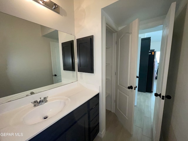 bathroom featuring hardwood / wood-style flooring and oversized vanity